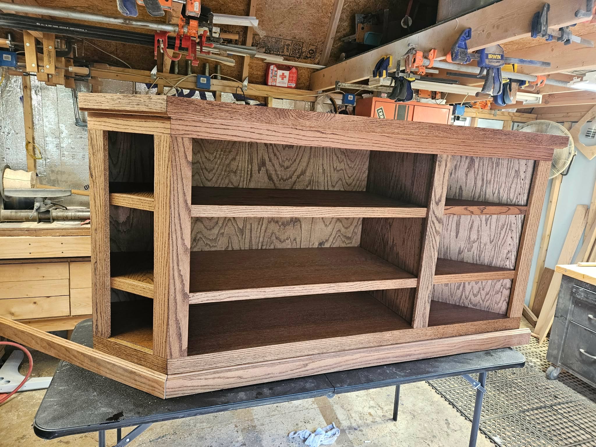 Custom oak entertainment and bookcase unit in workshop